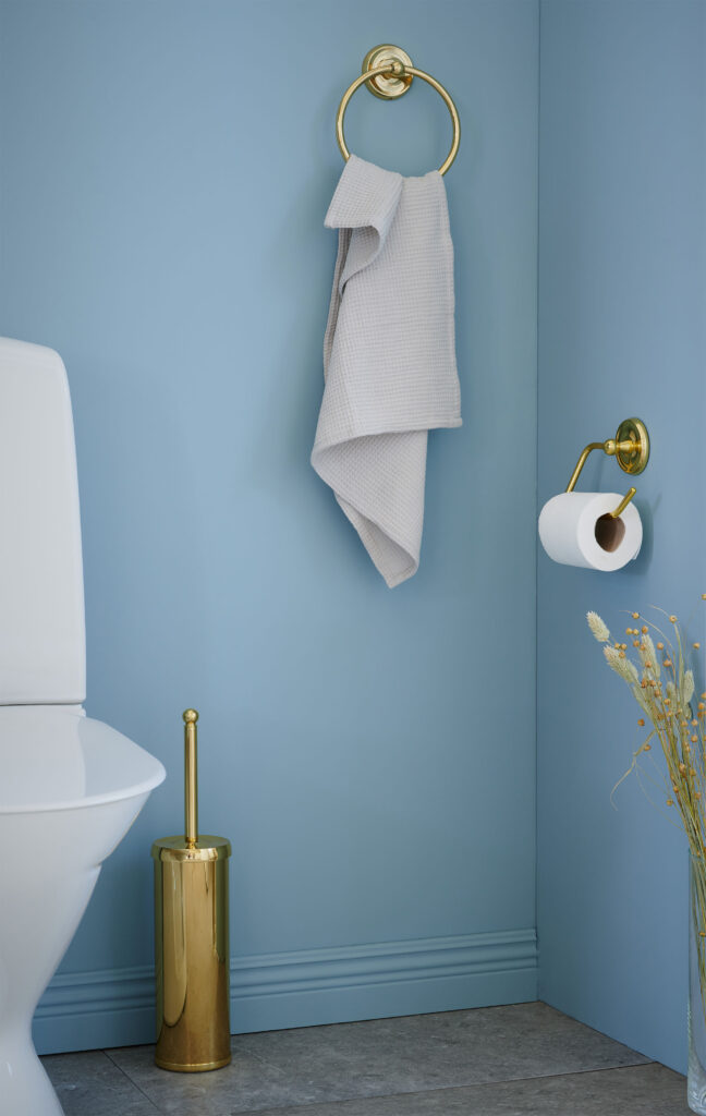 Smedbo products in polished brass in light blue bathroom