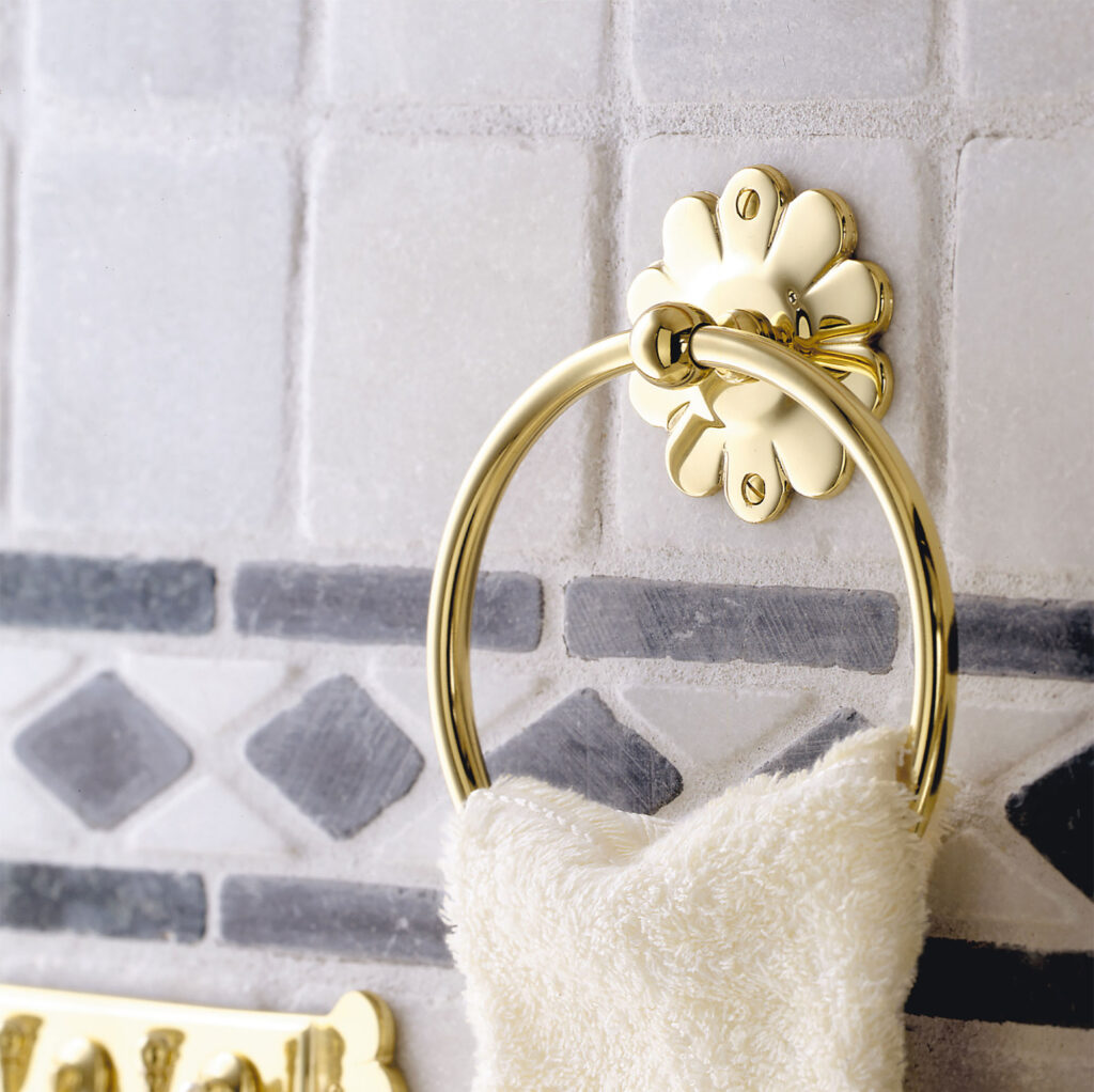 Smedbo towelring with a flower shaped backplate from the series Herrgård in solid brass