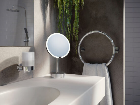 fristanding mirror, towel heater and soap dispencer in dark nicelooking bathroom