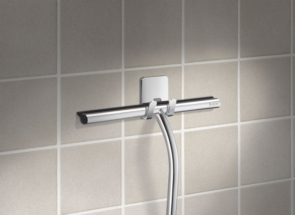 shower squeeguee on self adhesive hanger mounted on tiles